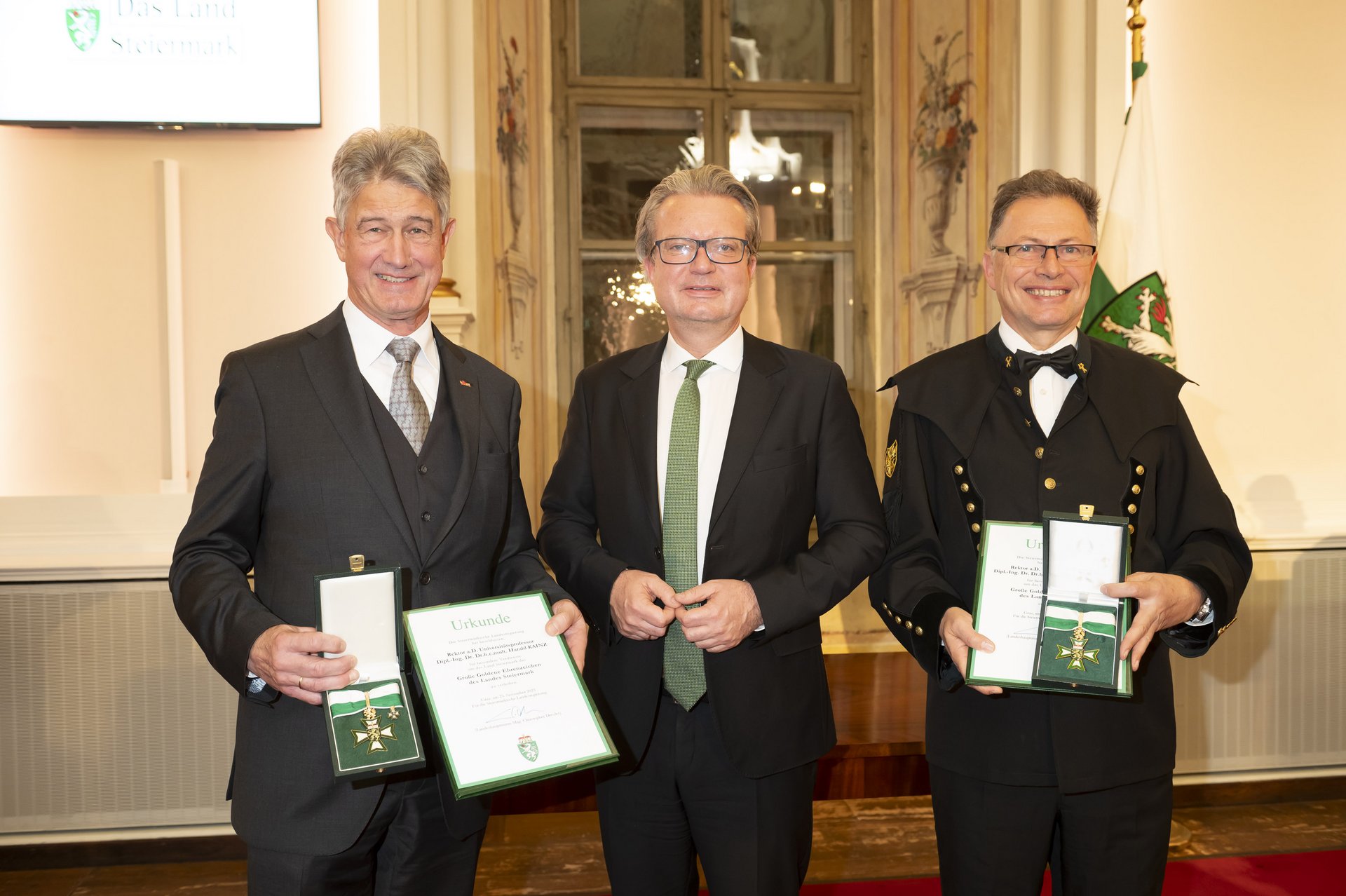 Landeshauptmann Christopher Drexler (Mitte) übergibt die Goldenen Ehrenzeichen an Altrektor Wilfried Eichlseder (re.) und TU Graz-Altrektor Harald Kainz.
