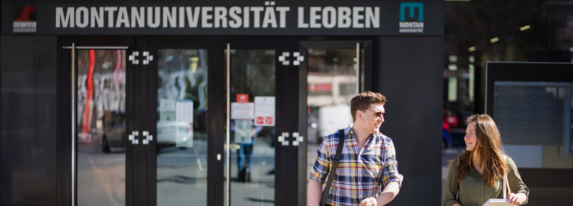 Eine Studentin und ein Student vor der Montanuniversität Leoben.
